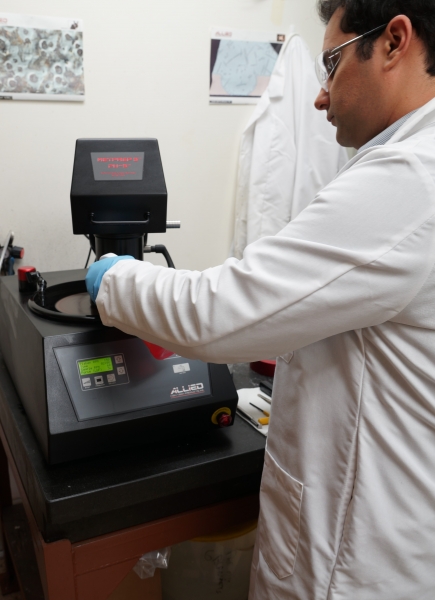 Lab tech polishing a metallurgic project part